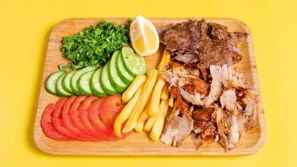 Beef and chicken portion doner kebab with fries on tray
