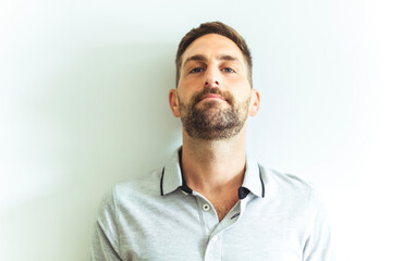 Close-up daylight portrait of young smiling handsome man isolated on gray background