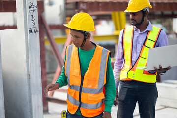 Professional engineering teamwork. Asian indian construction architect Engineering man and senior worker in safety hardhat working on laptop computer at Prefabricated concrete factory Heavy industrial