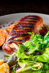 Roasted Duck breast fillets with vegetable salad and batat in plate
