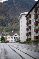 View of buildings and alpine mountains. The architecture of a resort town in Switzerland.