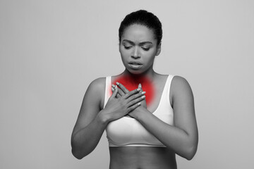 African american woman with chest pain touching her breast