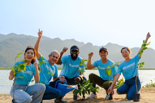 group of diverse volunteer enjoy charitable social working outdoors together planting tree for social responsibility, stop climate change, global warming, sustainable environment and better world