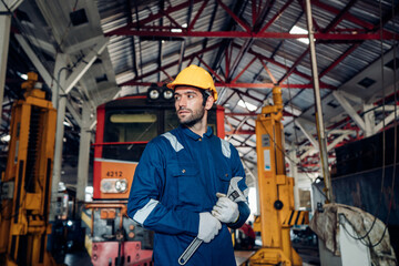Obraz na płótnie Canvas Engineer railway wearing safety uniform and helmet under checking under train ,wheels and control system for safety travel passenger. Banner cover design.