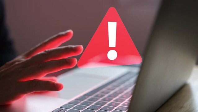 Businessman man hands are bored when using notebook to work then there is lost device alert or red computer virus.