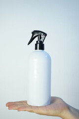 hand with spray bottle