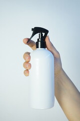 hand holding bottle of perfume