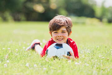 Young soccer player having fun on a field with ball