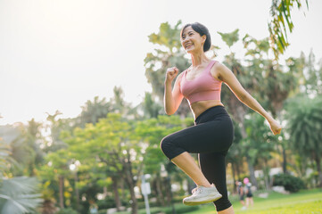 strength female jogger, fit young Asian woman 30s wearing pink sportswear, showing powerful body in park. healthy outdoor lifestyle fitness runner girl, at sunset. wellness and well-being concept.