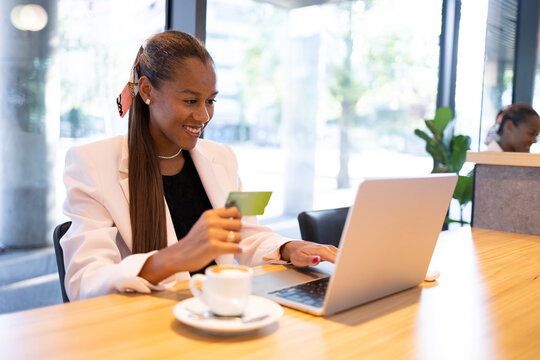 Happy woman doing online purchase