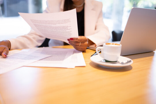Crop woman doing paperwork in office