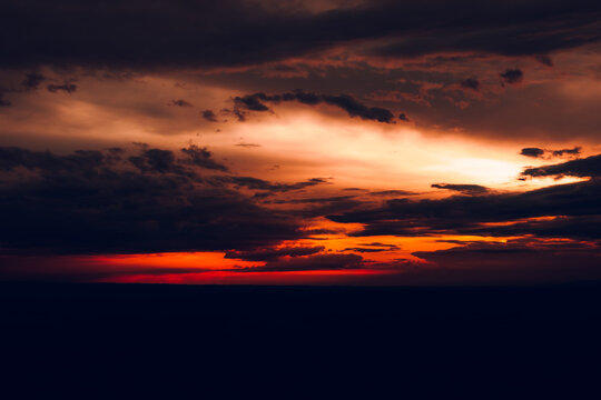 Beautiful view of the evening orange sky with black clouds