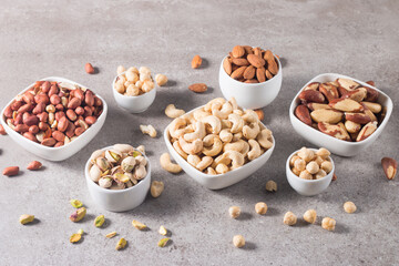 Healthy mix nuts on wooden background. Almonds, hazelnuts, cashews, peanuts, pistachios, Brazilian nuts