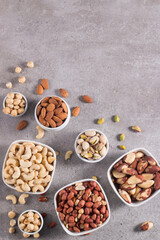 Healthy mix nuts on wooden background. Almonds, hazelnuts, cashews, peanuts, pistachios, Brazilian nuts