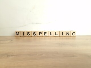 Word misspelling made from wooden blocks