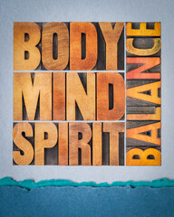 body, mind and spirit balance - a collage of text in vintage wood letterpress printing blocks against art paper, holistic approach to wellbeing and lifestyle concept