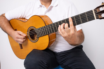 Fototapeta na wymiar close-up of adult man playing guitar isolated over white background.