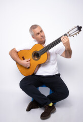 Obraz premium young adult man playing guitar isolated on white background