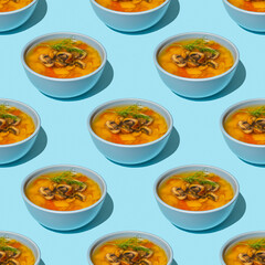 Seamless pattern with Mushroom Soup in ceramic bowl over blue wooden.