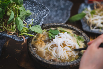 Bun Bo Hue, Bun Bo, Vietnamese beef noodle soup spicy in stone bowl