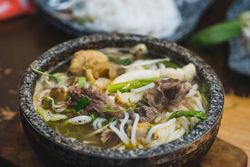 Bun Bo Hue, Bun Bo, Vietnamese beef noodle soup spicy in stone bowl