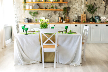 Interior design scandinavian kitchen with table and chair. Cozy Wooden white cuisine decorated with flowers and decor. Kitchen utensils, dishes, plates on shelves. Stylish dining room with furniture	
