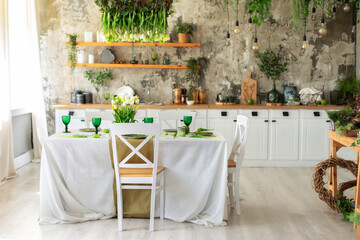 Interior design scandinavian kitchen with table and chair. Cozy Wooden white cuisine decorated with flowers and decor. Kitchen utensils, dishes, plates on shelves. Stylish dining room with furniture