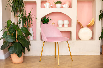 Modern composition of wabi sabi interior with arch shelf with home decoration and pink chair....