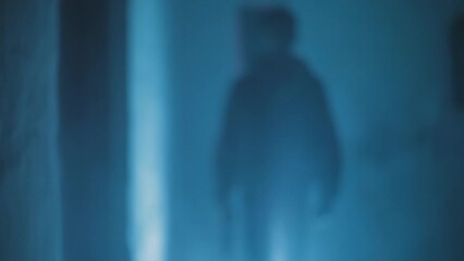 Front side shot of a man being chased. Hd footage of  a man with a gun in his hand being chased, running across the corrider.
