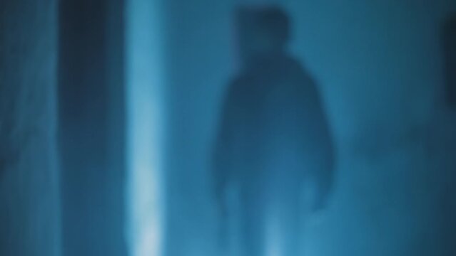 Front side shot of a man being chased. Hd footage of  a man with a gun in his hand being chased, running across the corrider.

