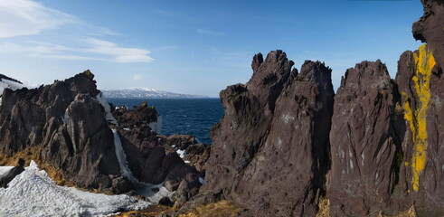 Russia. Far East, Kuril Islands. Very hard and sharp basalt rocks along the coast of the Sea of Okhotsk on the island of Iturup.