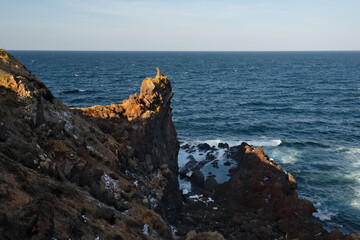 Russia. Far East, Kuril Islands. Very hard and sharp basalt rocks along the coast of the Sea of...