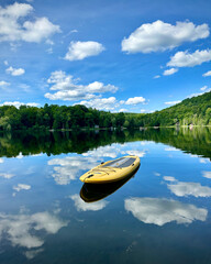 A standup paddle board floats on a  lake.