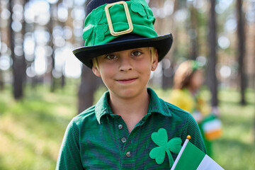 Cheerful little boy celebrates Saint Patricks Day dressed as a leprechaun