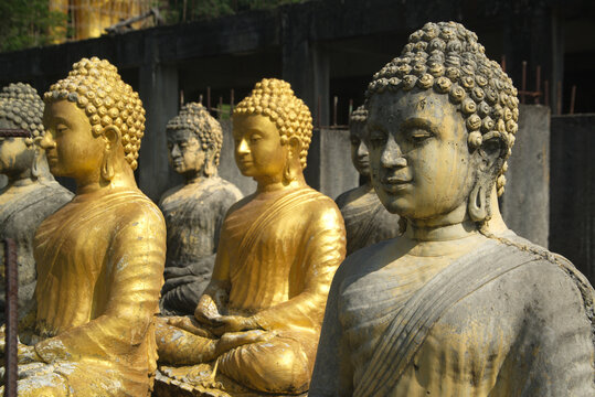 Group of Buddha statues sitting outdoors enshrined and decorated for Buddhists Worship at Wat Pa Sawang Boon. Located at Saraburi Province in Thailand.