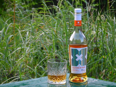 Glenmorangie X single malt whisky on a table in a summer garden - Aimusovo, Russia - July 2023