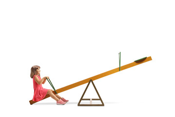 Little girl sitting on a seesaw alone