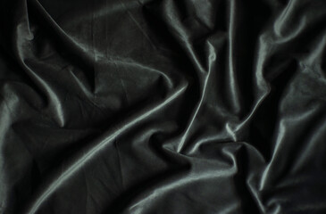 Black velvet with folds, luxury silk fabric background