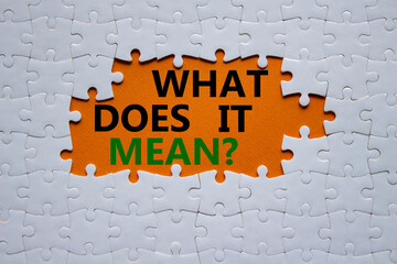 What does it mean symbol. White puzzle with words What does it mean. Beautiful orange background....