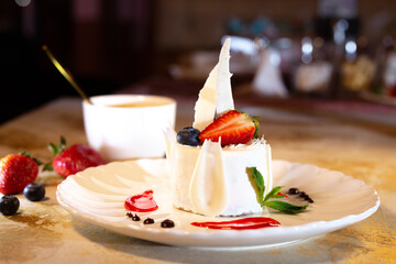 a beautiful fresh white dessert in a restaurant on the table. original dessert serving