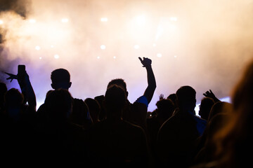 Fototapeta premium Abstract photo of crowd at concert and blurred stage lights.