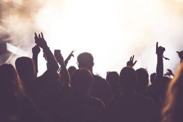 Abstract photo of crowd at concert and blurred stage lights.