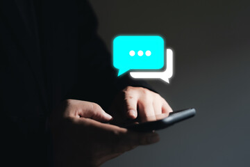 Businessman using smartphone typing live chat and social network concept. A conversation running on a mobile phone in the chat box icon appears. social media marketing technology
