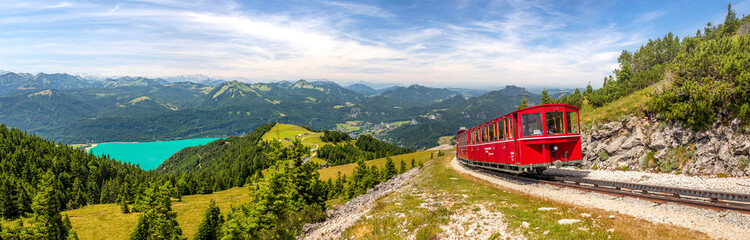 landscape with mountains and a lake Wolfgangsee and Schafberg cog railway train Schafbergbahn,...