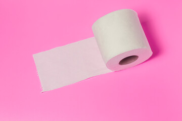 white toilet paper roll on pink background close up