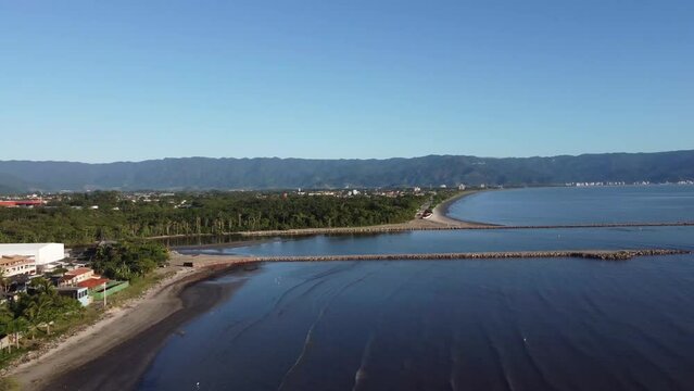 Small coastal village with peaceful beach and beautiful mountains