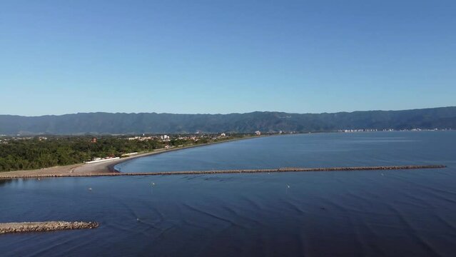 Small coastal village with peaceful beach and beautiful mountains
