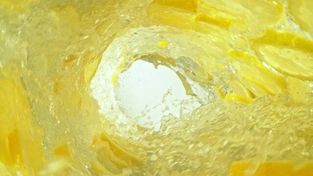 Super Slow Motion Shot of Lemon Slices and Water Rotating in Wave at 1000fps.
