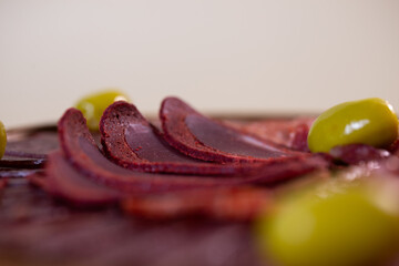 close-up of meat sliced from delicacies on a wooden stand.