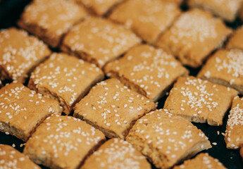 Square homemade cookies with sesame seeds.